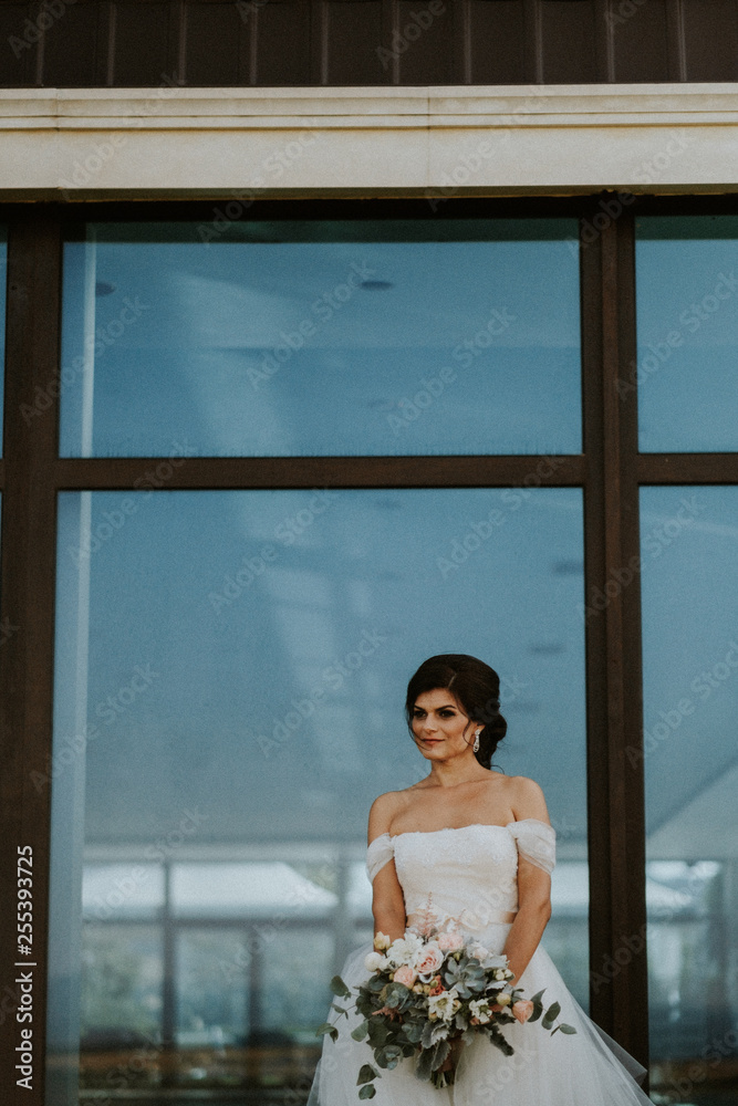 Bride with bouquet in front of a window Bride with bouquet in front of a window