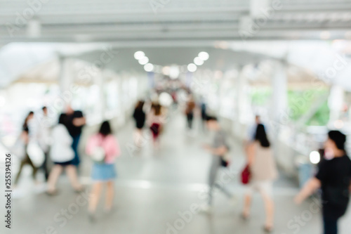many people walking on the skywalk with blurry image