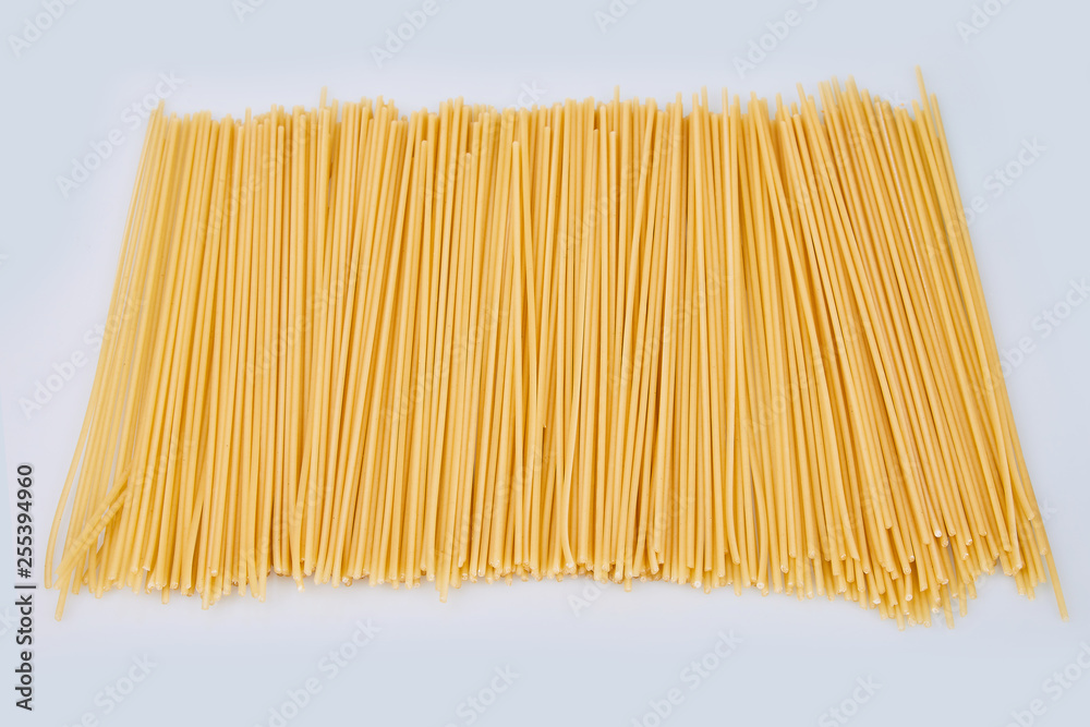 Spaghetti isolated on white background. Yellow sheaf raw long pasta, ready for cooking. Italian pasta. Long spaghetti. Raw spaghetti bolognese Spaghetti isolated on white background. Yellow sheaf raw long pasta, ready for cooking. Italian pasta. Long spaghetti. Raw spaghetti bolognese