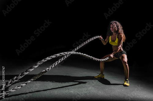 woman training crossfit with ropes