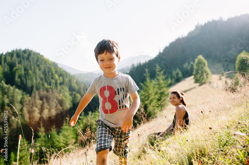 Young mom with baby boy travelling. Mother on hiking adventure with child, family trip in mountains. National Park. Hike with children. Active summer holidays. Fisheye lens photo