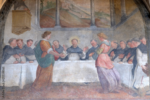 San Dominic in Mensa fed by the Angels, fresco by Santi di Tito in the cloister of Santa Maria Novella Principal Dominican church in Florence, Italy photo