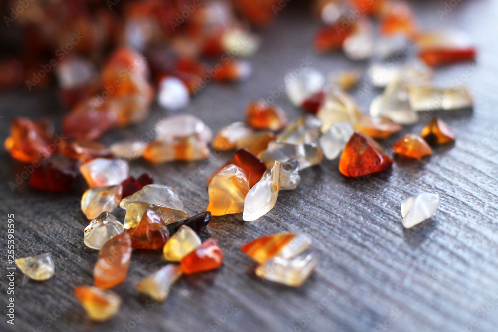 Natural brown stones for jewelry on wooden table Natural brown stones for jewelry on wooden table