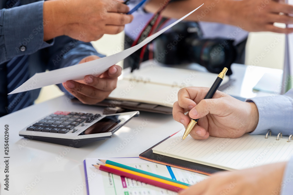 Magazine photographers meeting before working on models in studio.