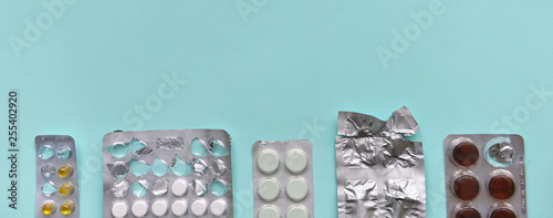 capsule pills in a blister pack, on a blue isolated background. The concept of global health. Antibiotics, drug resistance. Antimicrobial capsule tablets. Pharmaceutical Industry for Pain photo