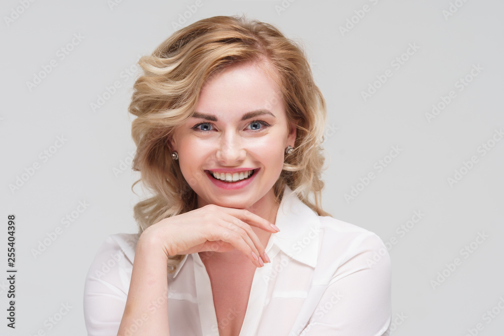 Image of happy curly woman in white shirt in studio. Image of happy curly woman in white shirt in studio.