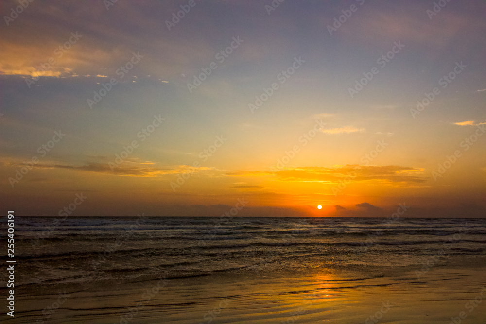 Sun rising over the mediterranean sea, the waves coming to the shore for this holiday background, love holidays, love the beach