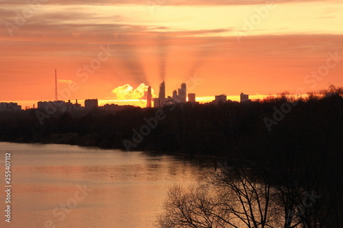 Golden dawn in the city over the river