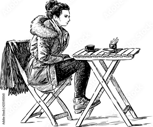 A young townswoman drinking tea in an outdoor cafe photo