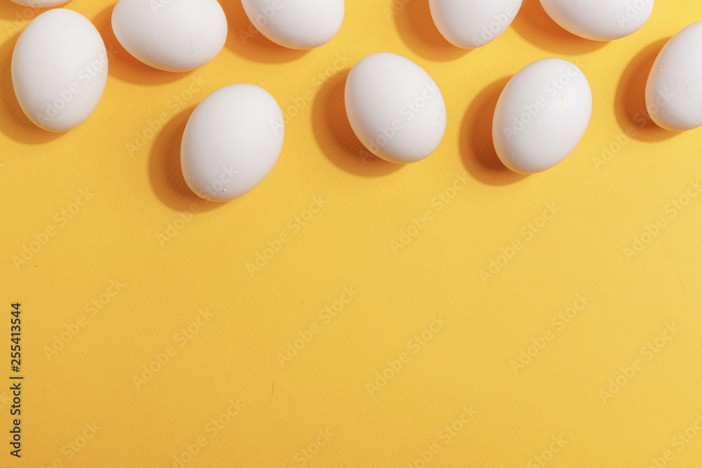 Set of white chicken eggs on a yellow background. Preparation for painting Easter eggs. Top view. Set of white chicken eggs on a yellow background. Preparation for painting Easter eggs. Top view.