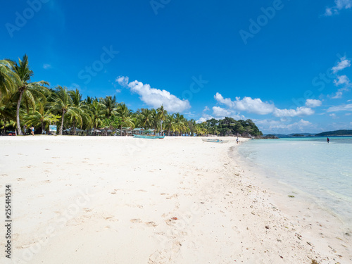 View of tropical beach on the island Malcapuya. Beautiful tropical island with sand beach, palm trees. Travel tropical concept. Palawan, Philippines. October, 2018