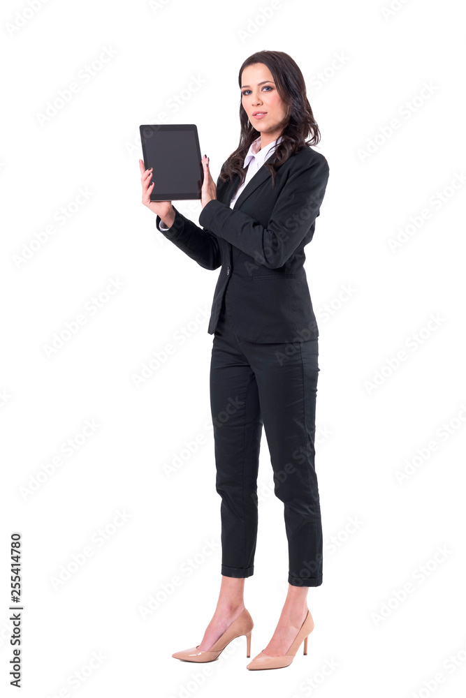 Confident successful business woman holding and showing black tablet screen with copy space. Full body isolated on white background. Confident successful business woman holding and showing black tablet screen with copy space. Full body isolated on white background.