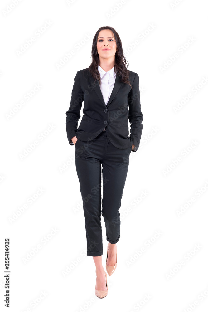 Successful female business manager or lawyer walking with hands in pockets. Full body isolated on white background. Successful female business manager or lawyer walking with hands in pockets. Full body isolated on white background.