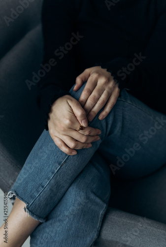 Women's hands close on jeans knees © Kseniia