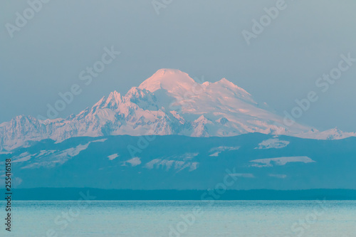 Mt Baker with winter snowpack and sunset pastel pink glow. photo