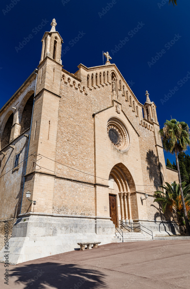 beautiful historic church building in light brown tones; palm in front of the building; ancient architecture