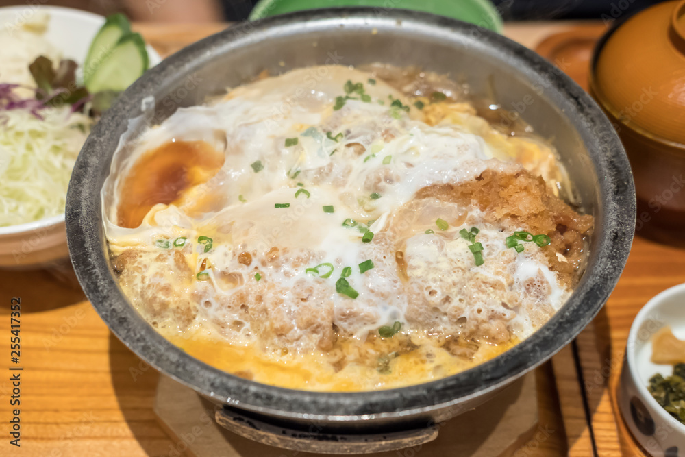 Katsudon, a popular Japanese food. It is a bowl of rice with fried pork cutlet, egg and vegetables