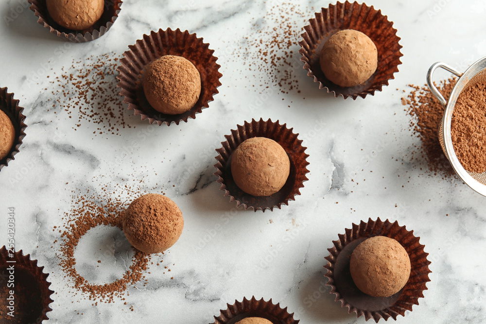 Flat lay composition with tasty raw chocolate truffles on marble background Flat lay composition with tasty raw chocolate truffles on marble background