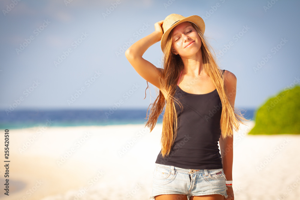 Summer exotic vacation maldive holiday background - happy young pretty caucasian girl take sunbath smiling and relaxing on white sand caribbean tropical beach with palms with warm weather on holiday
