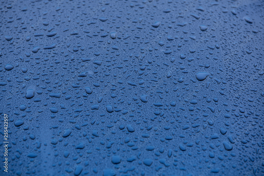 raindrops on blue glass surface raindrops on blue glass surface