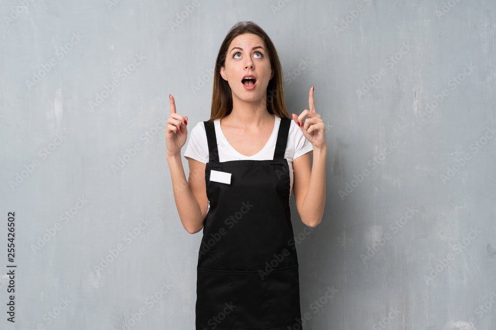 Employee woman surprised and pointing up