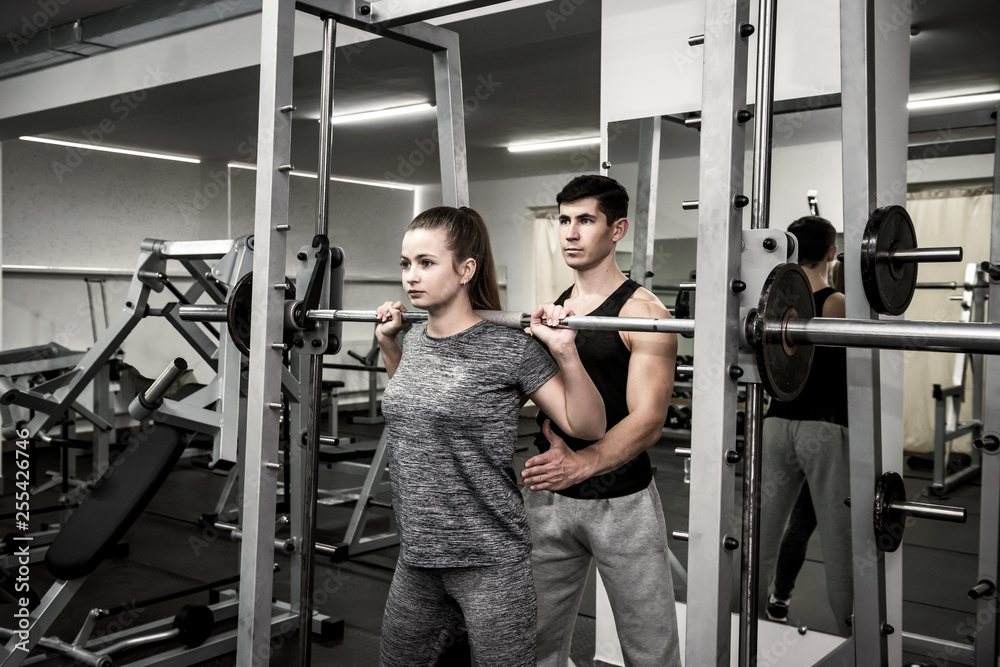 Man instructor working with woman in gym Man instructor working with woman in gym