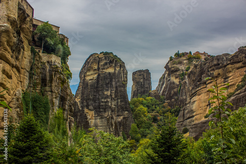 dramatic steep rocks with forest trees at the foot Asian nature scenery landscape in cloudy weather time