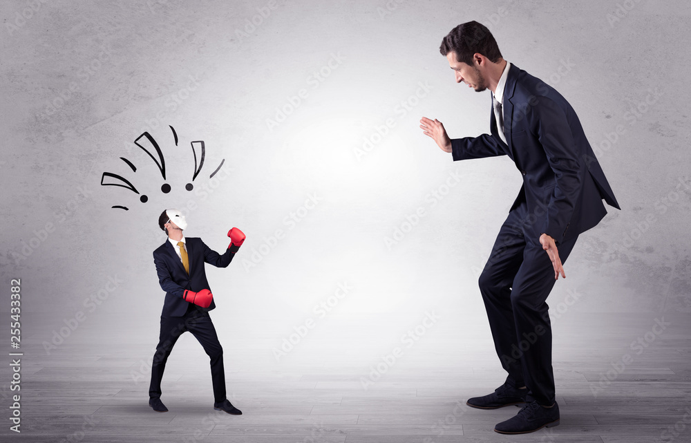 Big businessman being afraid of small masked businessman with box gloves in an empty room concept
Big businessman being afraid of small masked businessman with box gloves in an empty room concept
