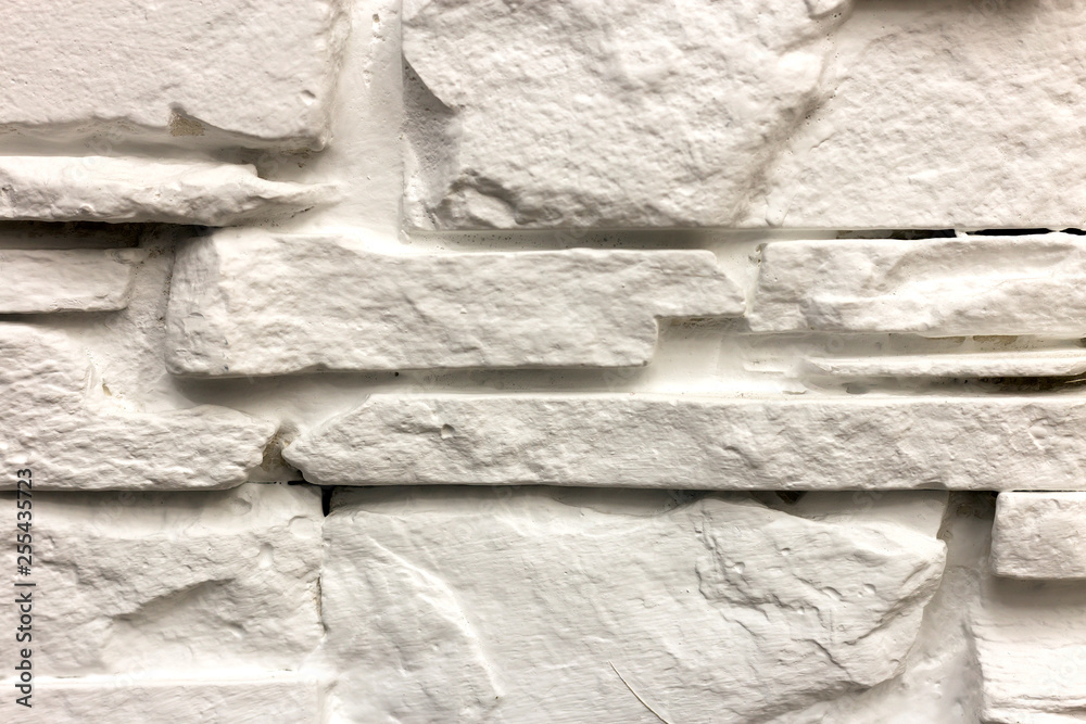 Close-up of white solid limestone wall or stone fence. Abstract copy space background, Bricklaying, construction and masonry concept. Close-up of white solid limestone wall or stone fence. Abstract copy space background, Bricklaying, construction and masonry concept.