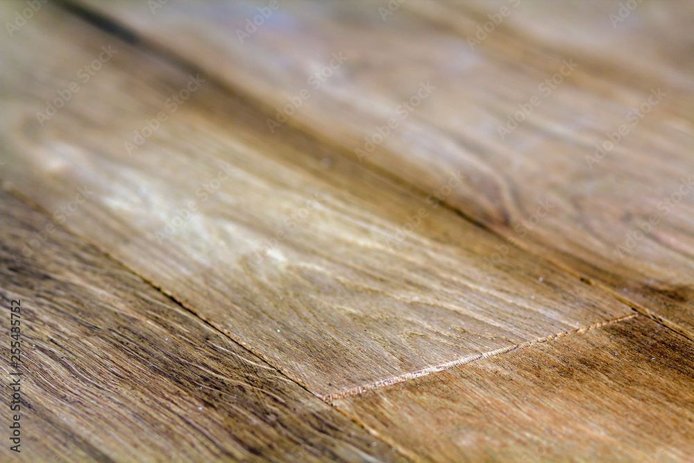 Fototapeta premium Natural light brown wooden parquet floor boards. Sunny soft yellow texture, copy space perspective background.