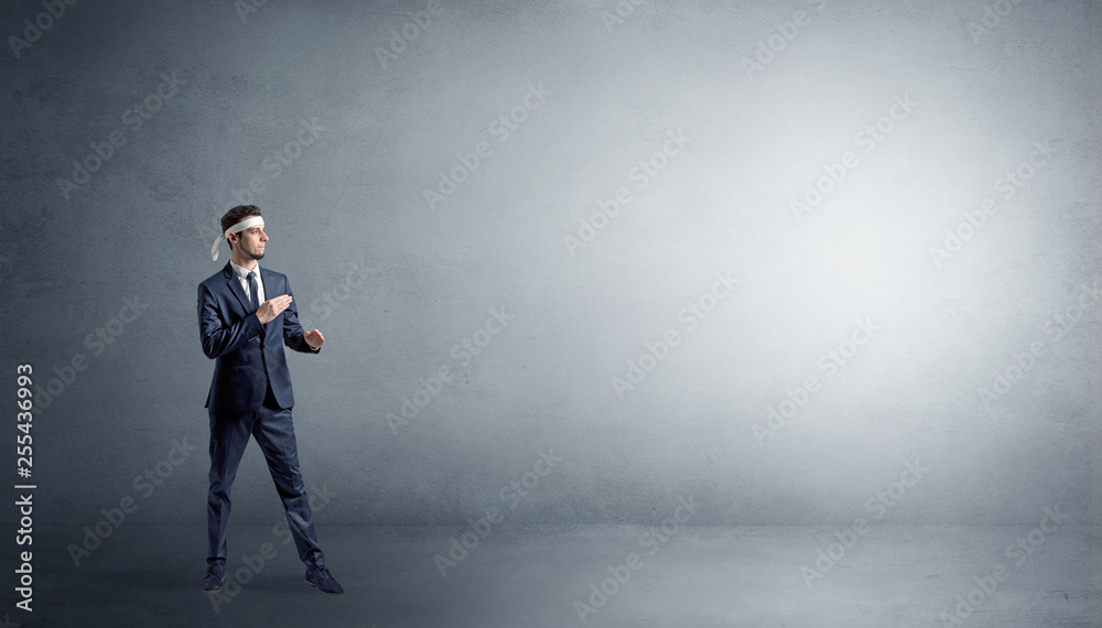 Small karate man fighting in an empty grey copy space Small karate man fighting in an empty grey copy space