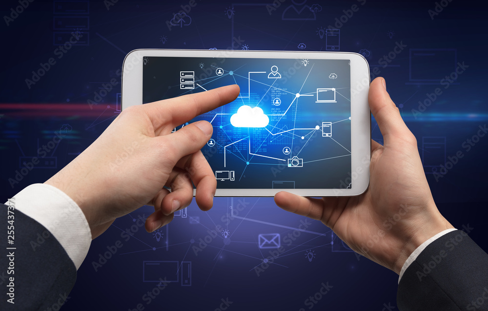 First person view of a hand using tablet with cloud office concept
First person view of a hand using tablet with cloud office concept