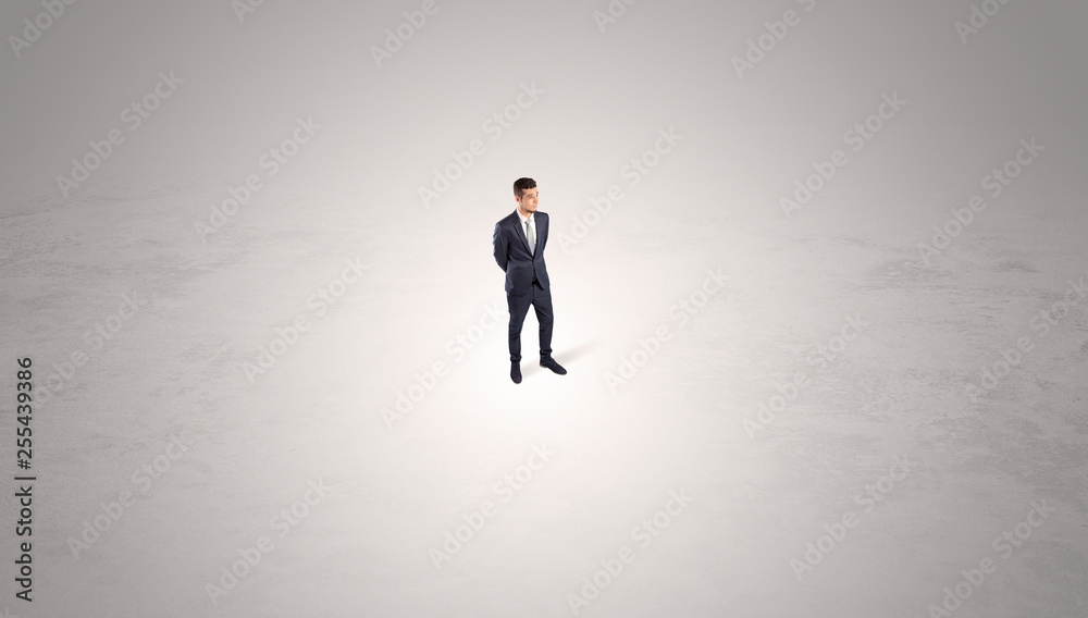 Young businessman standing alone in the middle of an empty space
Young businessman standing alone in the middle of an empty space