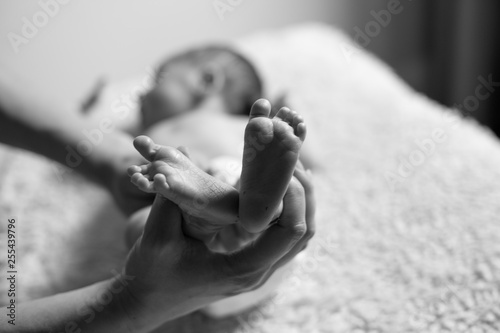 Baby feet with mom holding them