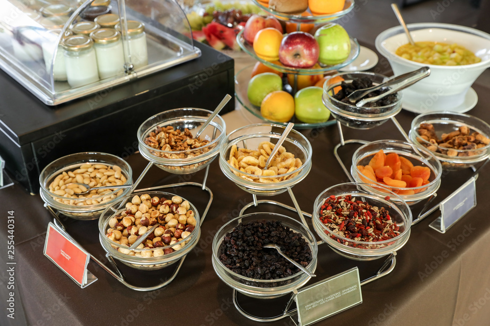 Variety of dried nuts and berries for healthy breakfast buffet table as well some fruits and yoghurts in greek hotel.