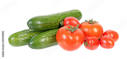 Fresh green cucumbers and red tomatoes isolated on white background. Ingredients for vegetable salad