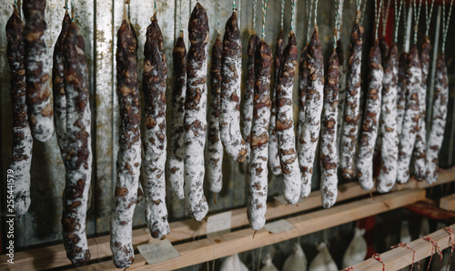 Traditional cured french sausages in the store at Franche Comte smoke house photo