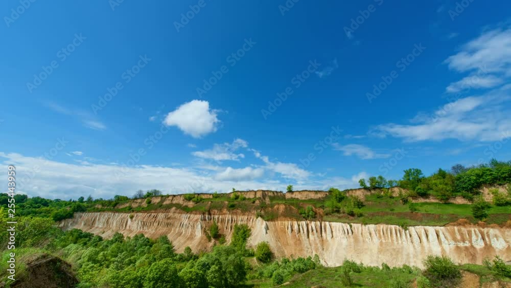 Beautiful blue sky with running clouds. Old abandoned chalk quarry. Formation of rain clouds. Time lapse video. 4k footage. 