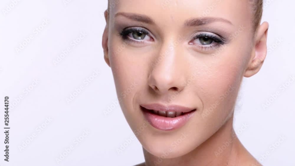 CLoseup face of an young woman with clean skin of a face. Healthy beautiful woman cares of face skin. Full Hd footage. Beauty treatments. Closeup portrait of young adult caucasian girl looks at camera CLoseup face of an young woman with clean skin of a face. Healthy beautiful woman cares of face skin. Full Hd footage. Beauty treatments. Closeup portrait of young adult caucasian girl looks at camera