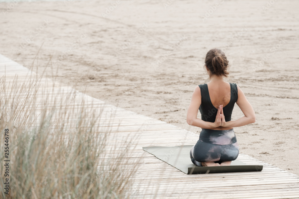 Fototapeta premium a female practicing yoga and meditation
