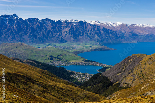 peaceful landscape during sunny day above the lake, valley and mountain range