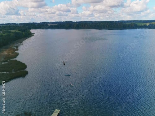 aerial shot of a kayak and boat on lake in the fall