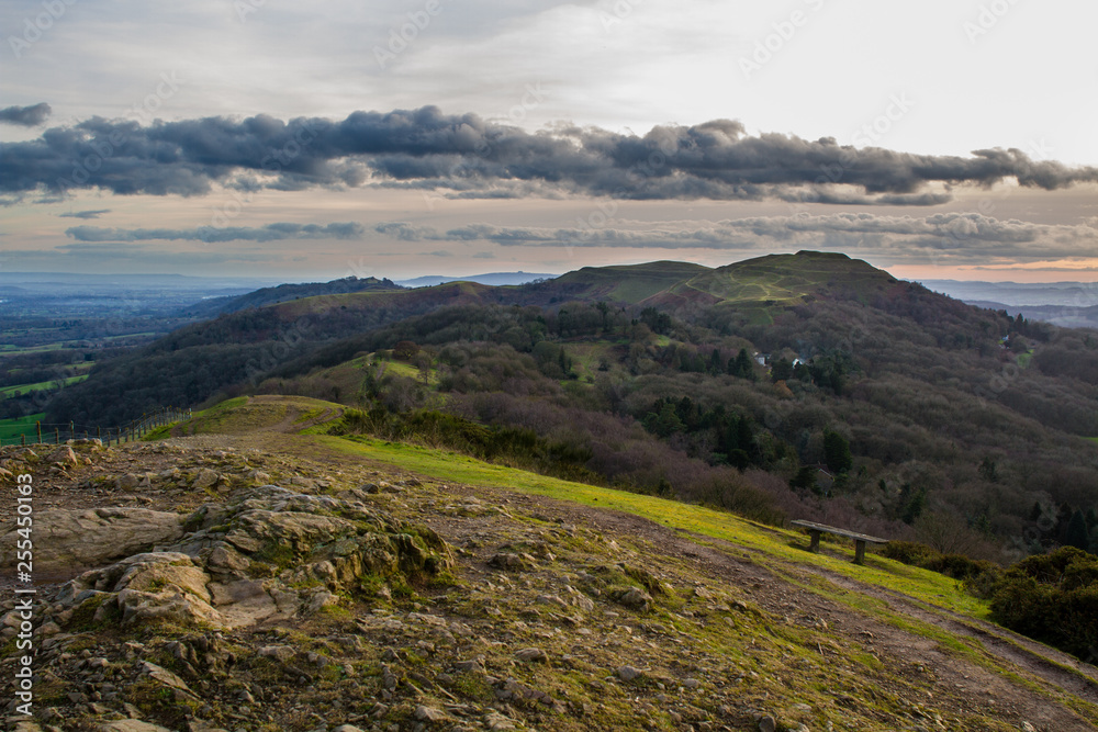Rocky hilltop with southern part of the malvern hills including herefordshire beacon in the background