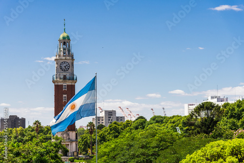 Torre Monumental (Torre de los Ingleses) clock tower in Retiro neighborhood, Buenos Aires, Argentina with the flag of Argentina photo