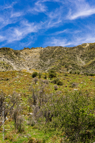 green steep mountain hill, sunny warm day