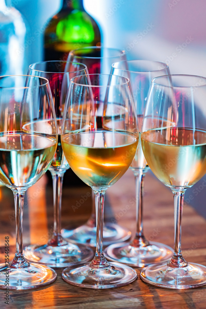 Wine glasses on white background in bright lights Wine glasses on white background in bright lights