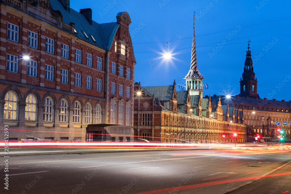 city road and old architecture in twilight with car light trails in Copenhagen in Denmark