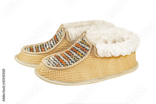 Warm high home slippers made of sheep wool isolated on white background