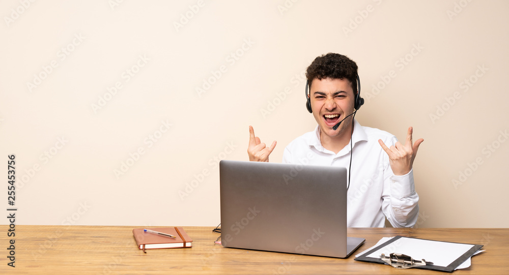 Telemarketer man making rock gesture Telemarketer man making rock gesture