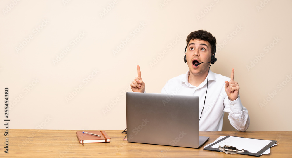 Telemarketer man surprised and pointing up